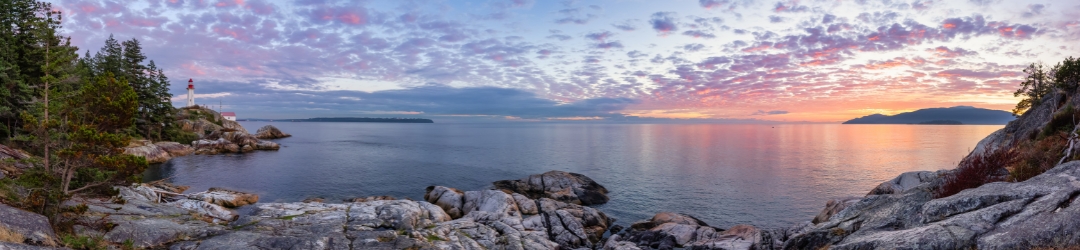 Panoramic view of a Lighthouse Park on a rocky coast during a dramatic cloudy sunset. Horseshoe Bay, West Vancouver