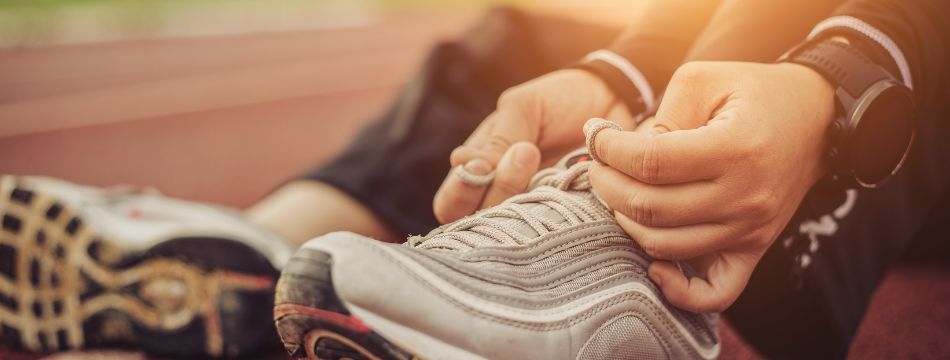 Person tying up sneakers